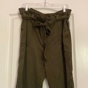 Army green, high-rise paper bag waist pants.